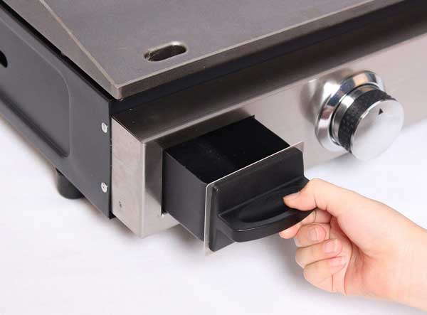 A hand pulls out a small drawer from a shiny metal box