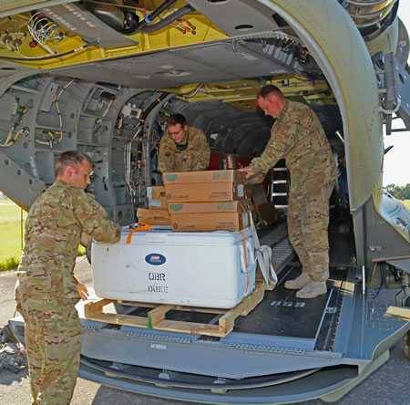 Military delivering meals from Operation BBQ Relief